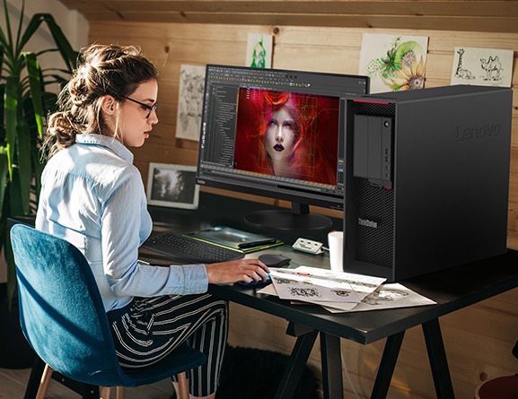 Lenovo ThinkStation P620 tower in use on a desktop, alongside monitor, keyboard, and mouse.